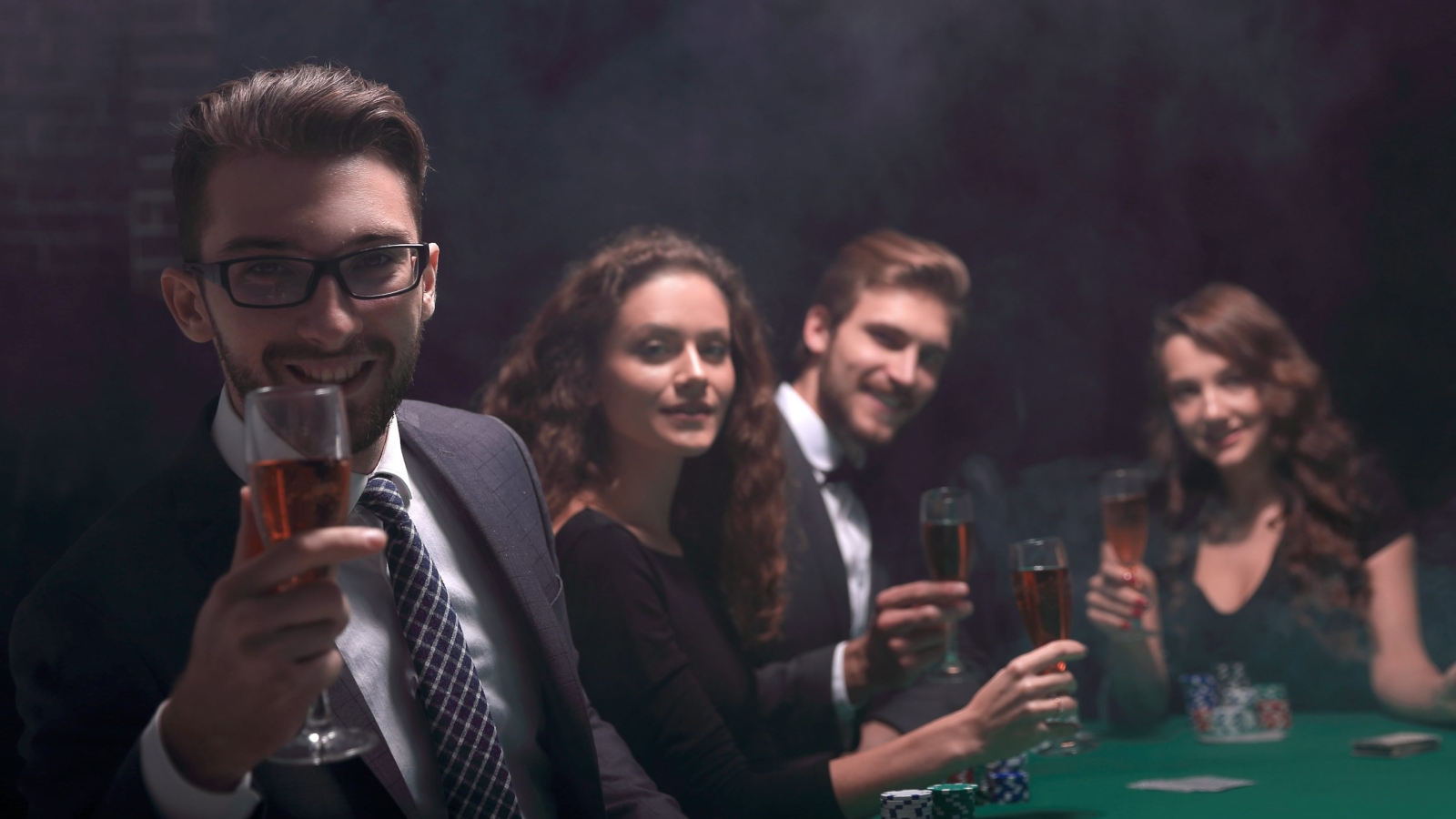 poker players with a glass of wine ,sitting at a table in a casino